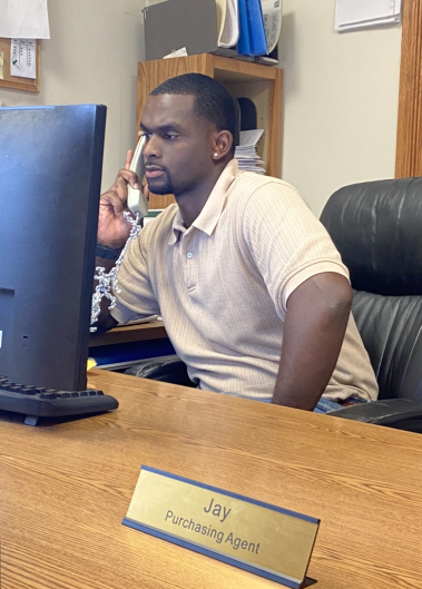 a man sitting at a desk with a computer doing one of our many onsite careers