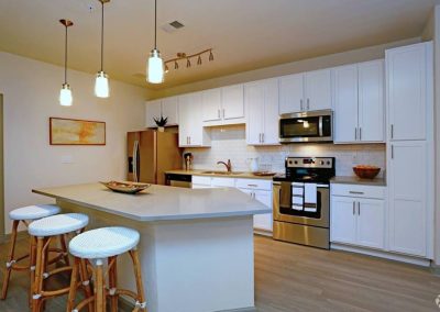 Acadia White Cabinets Finished Kitchen and Island Light Gray Counter Tops