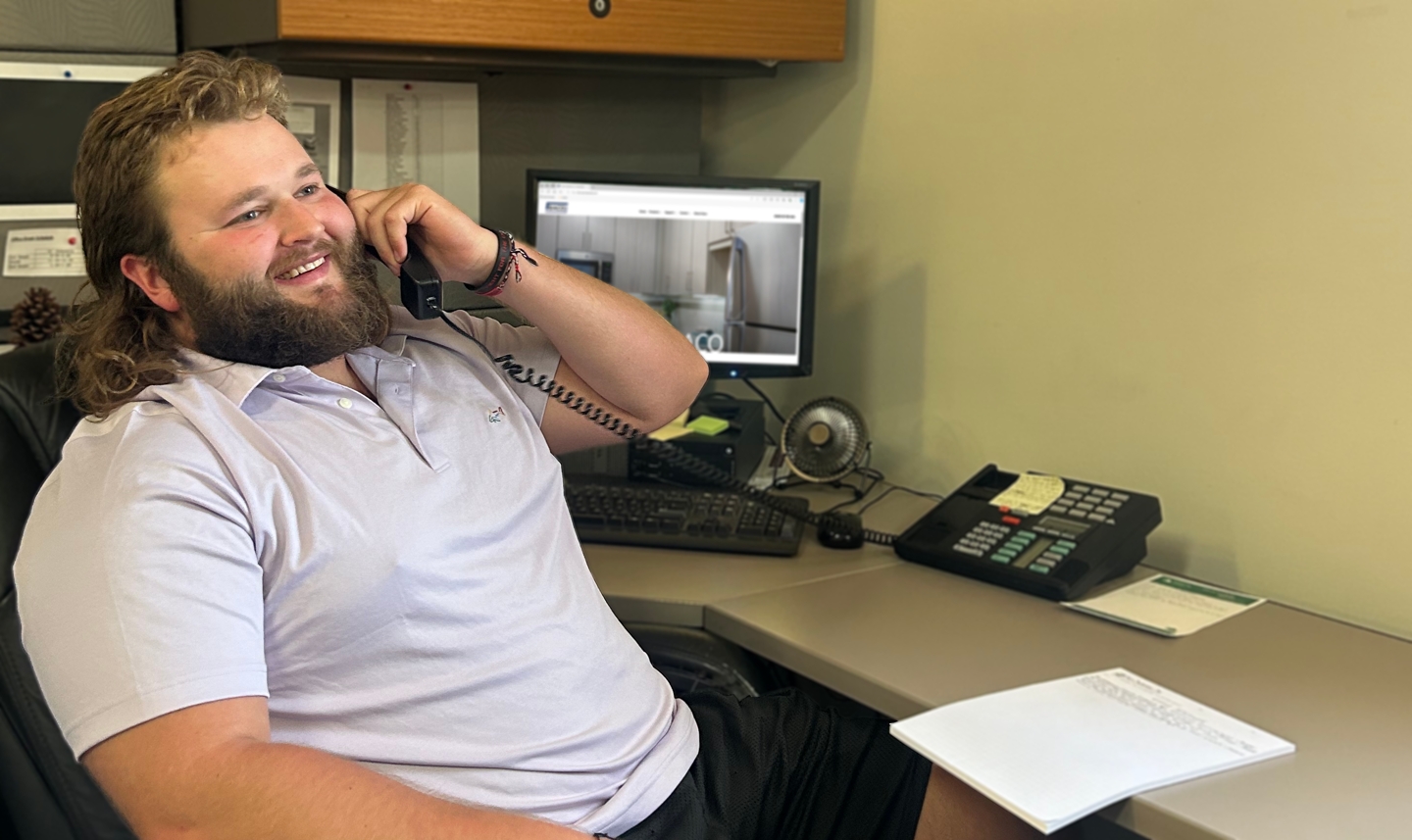 Saco Sales Representative on Phone Smiling Laughing Selling Cabinetry Background Blurred